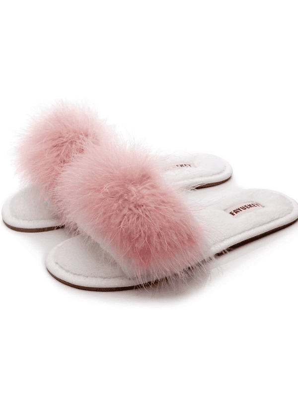 A pair of pink slippers on top of white background.