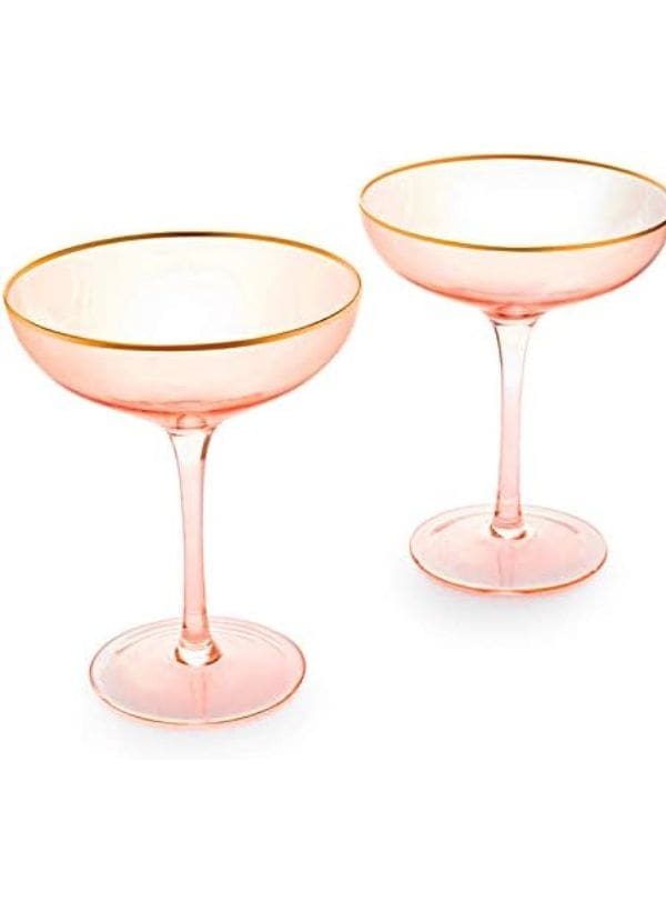 A pair of pink champagne glasses with gold rims.