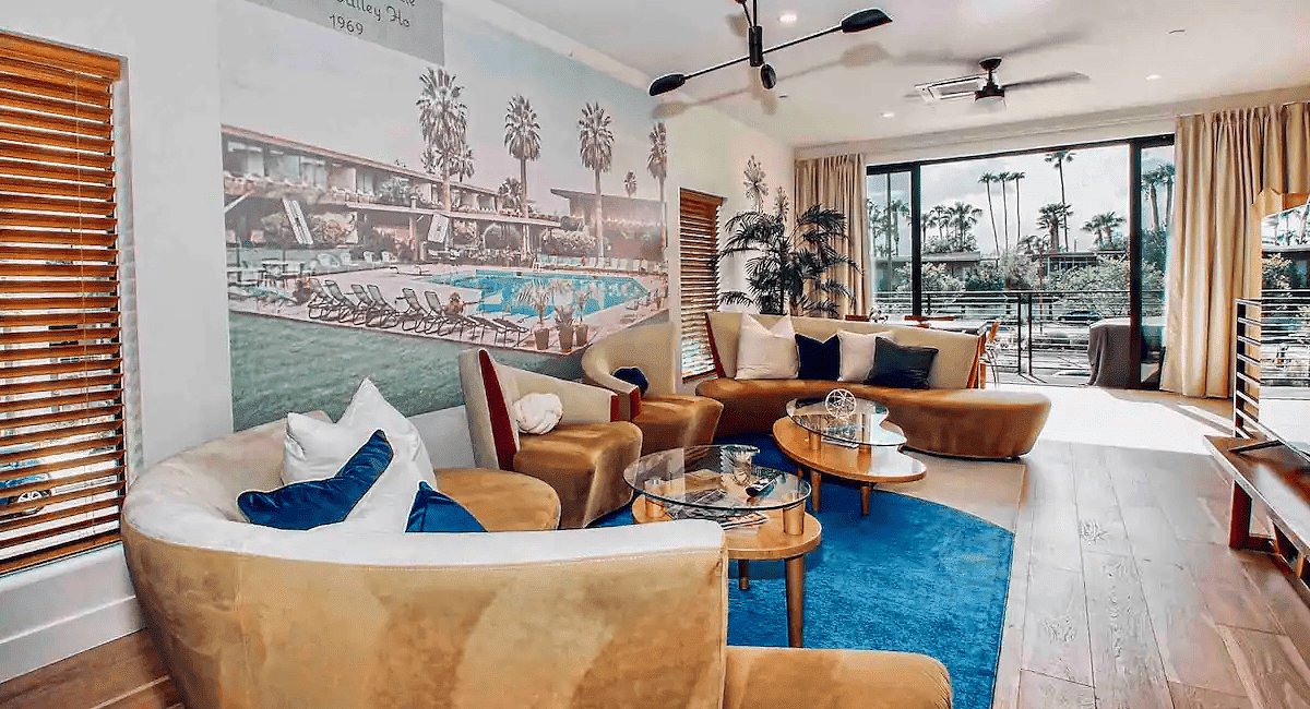 A living room with a large wall mural of a city.