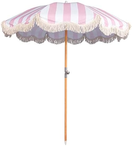 A pink and white umbrella with fringed edges.