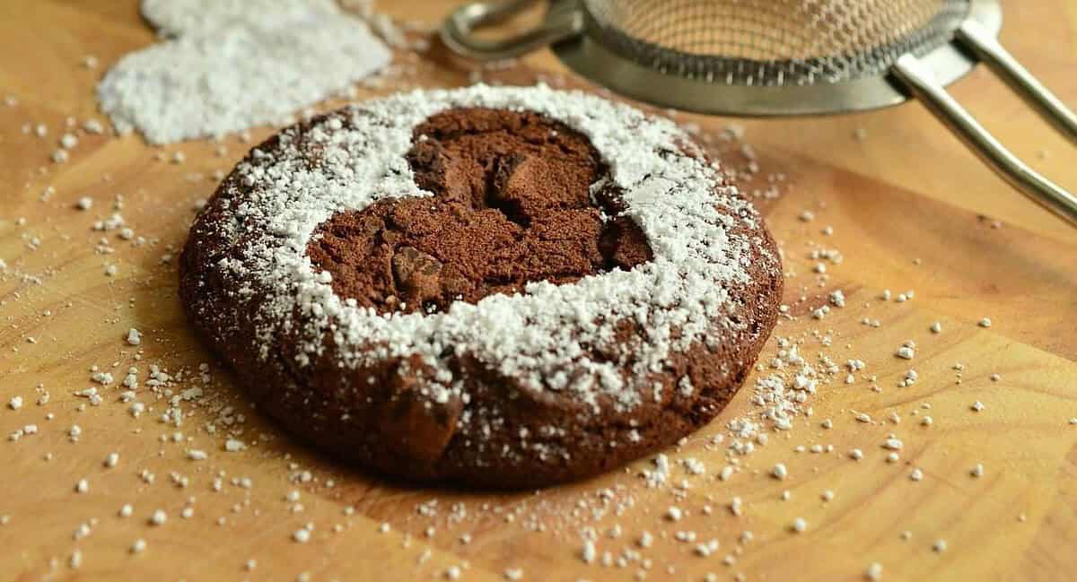 A cookie with powdered sugar on top of it.