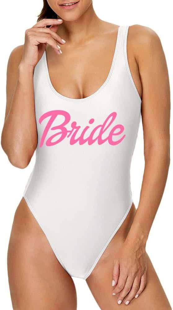 A woman in a white bathing suit with pink lettering