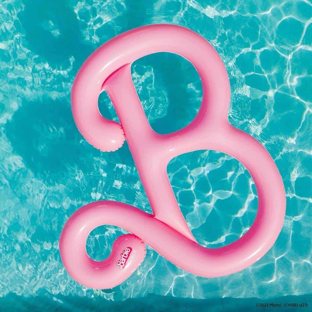 A pink letter b floating in the water.