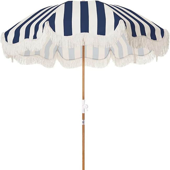 A blue and white umbrella with a wooden pole.