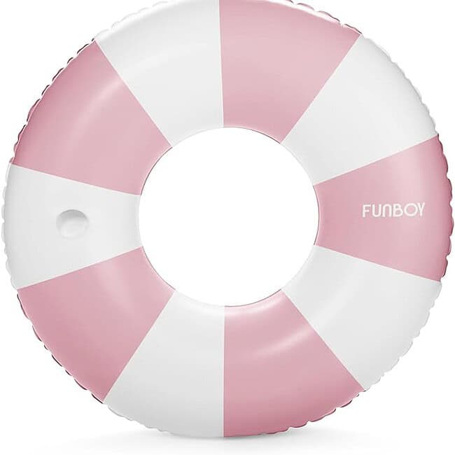A pink and white inflatable ring on top of the ground.