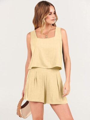 617AkW9T53L._AC_SY741_.jpg A woman in beige shorts and top holding a purse.