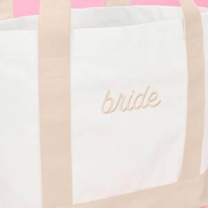 A close up of the bride 's name on her bag