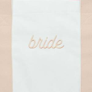 A white towel with the word bride written on it.