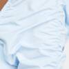 A person wearing white pants and a blue shirt.