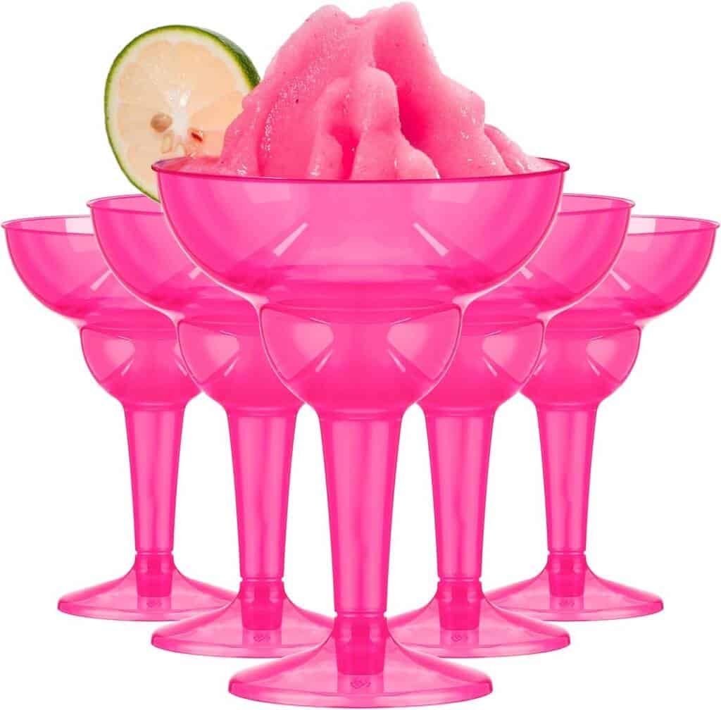A group of pink plastic cups with a lime slice in the middle.
