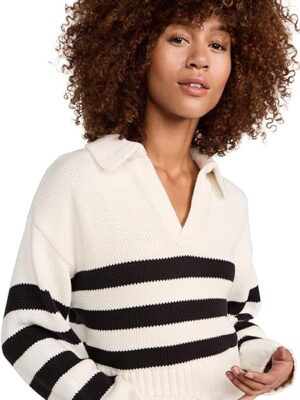 A woman with curly hair wearing a black and white striped sweater.
