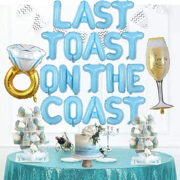 A Table With Balloons That Say &Quot; Last Toast On The Coast &Quot;.