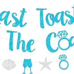 A banner that says toast the coast with blue glitter.