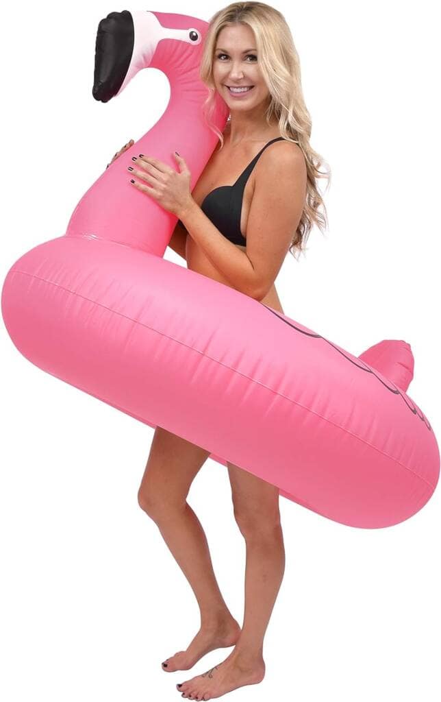 A woman in black bikini holding an inflatable pink object.