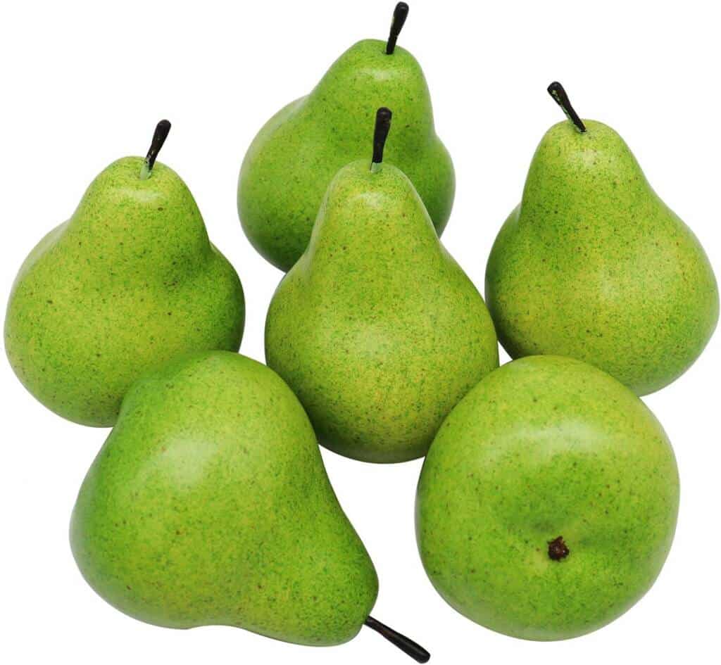 A group of green pears sitting on top of each other.