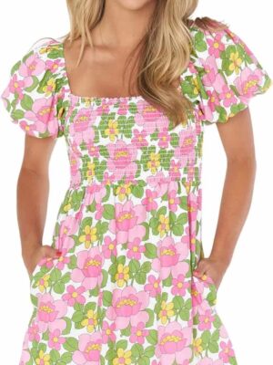 A woman in pink and green floral dress.