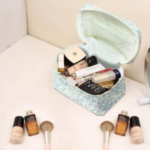 A makeup bag with some different cosmetics on it