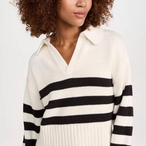 A woman wearing a black and white striped sweater.