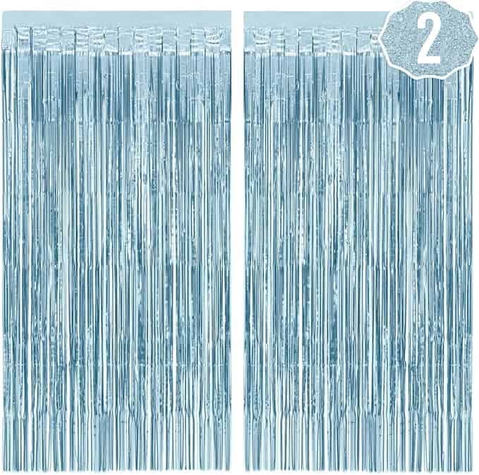 A pair of blue curtains with long silver metallic fringe.
