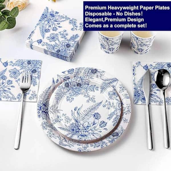 A Table Set With Plates, Silverware And Napkins.