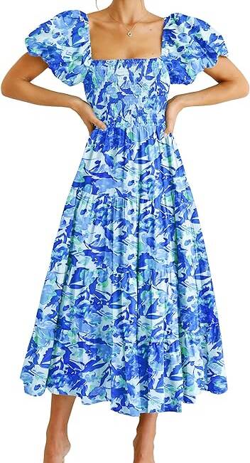 A woman in blue and white floral print dress.