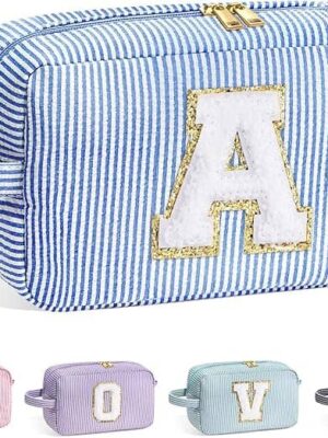 A striped cosmetic bag with the letter ' a ' in gold.