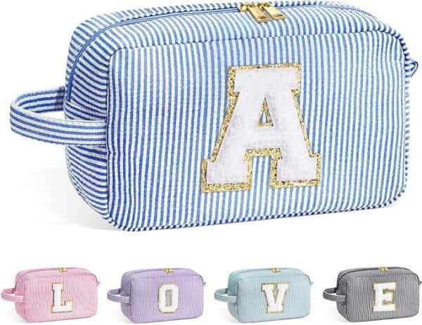 A striped cosmetic bag with the letter ' a ' in gold.