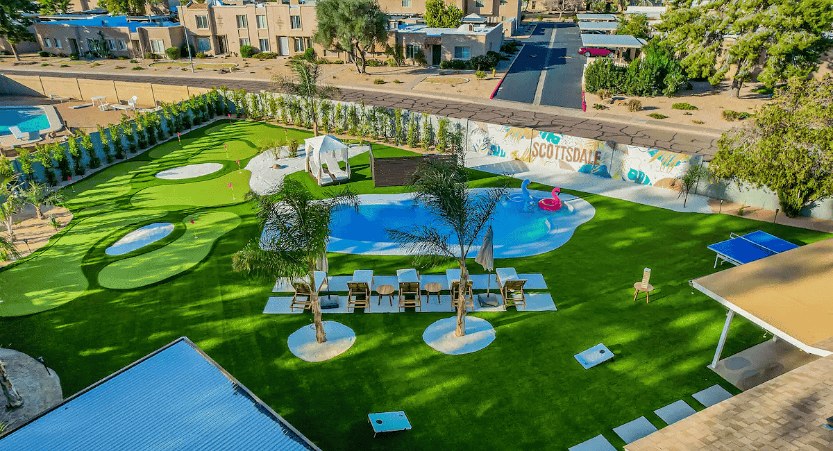 A view of a resort pool and putting green.