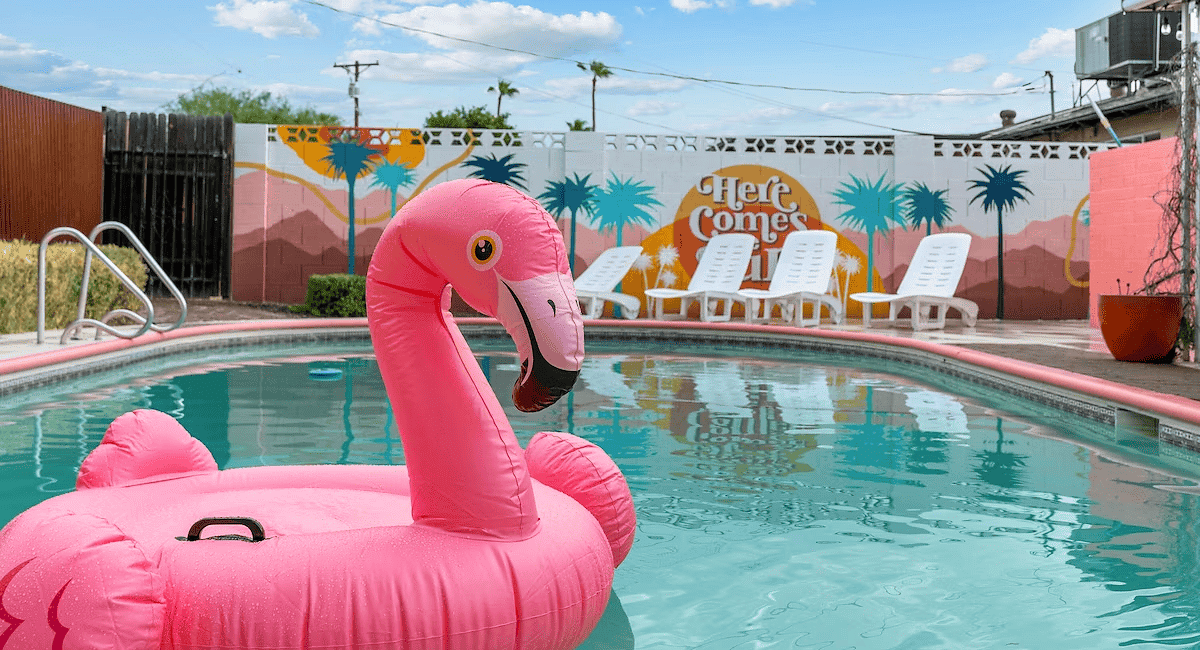 A pink flamingo float in the middle of an outdoor pool.