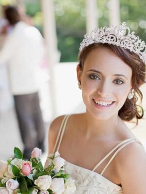 Bridal Crystal Tiara Crown A bride with a tiara and bouquet of flowers.