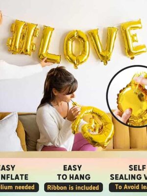 A woman is holding a balloon that says " love ".
