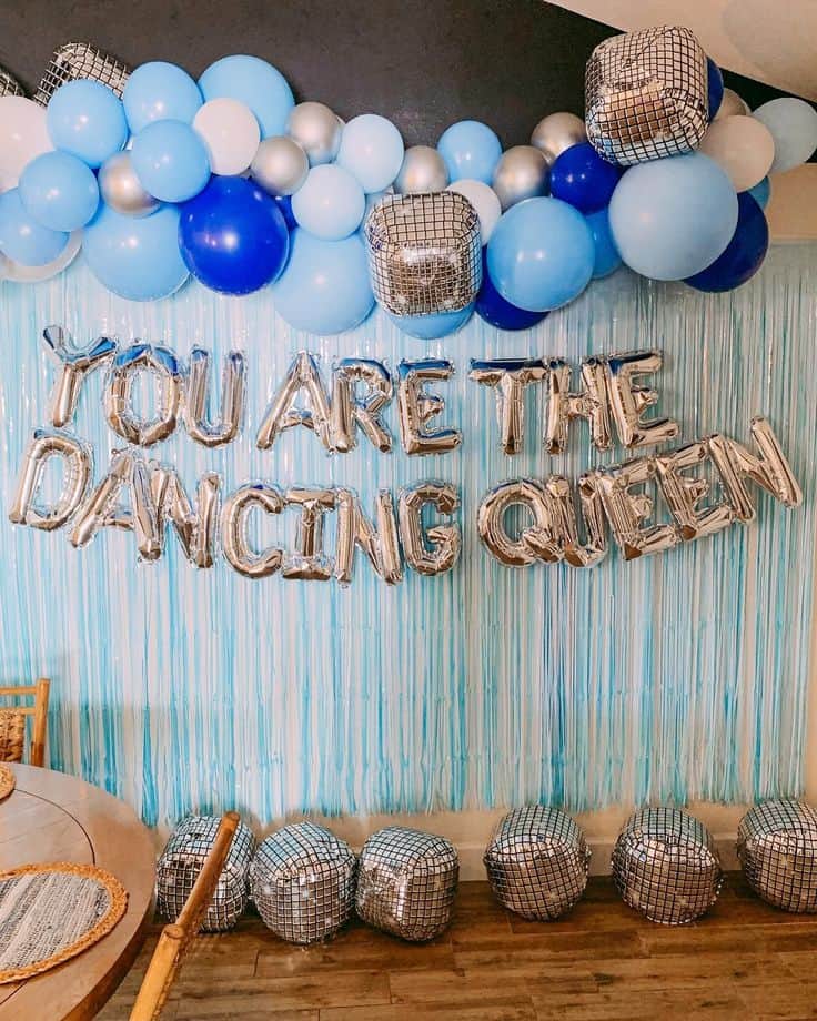 A party room with balloons and foil letters