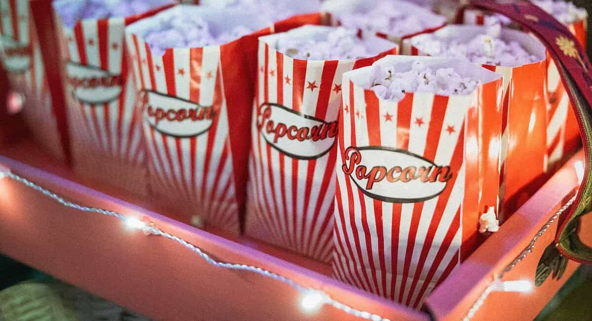 A tray of popcorn is shown with red and white stripes.