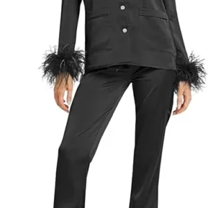 A woman in black suit with feathers on sleeves.