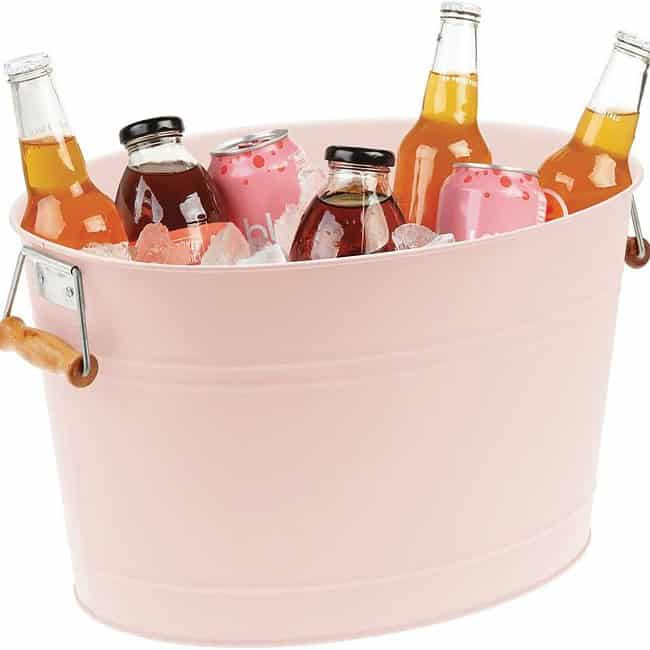 A pink tub with six bottles of beer in it.