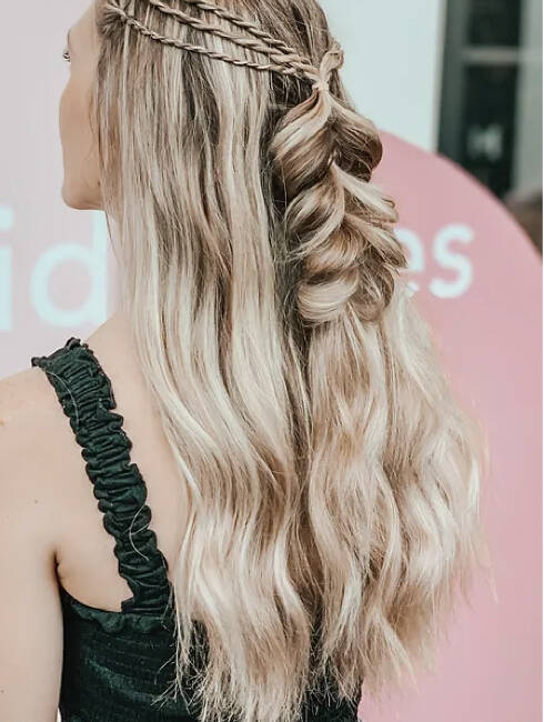 A woman with long blonde hair and a braid.