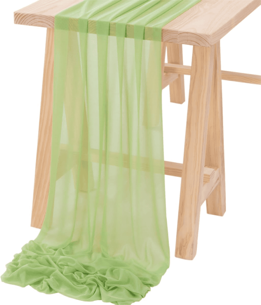 A wooden table with green cloth draped over it.