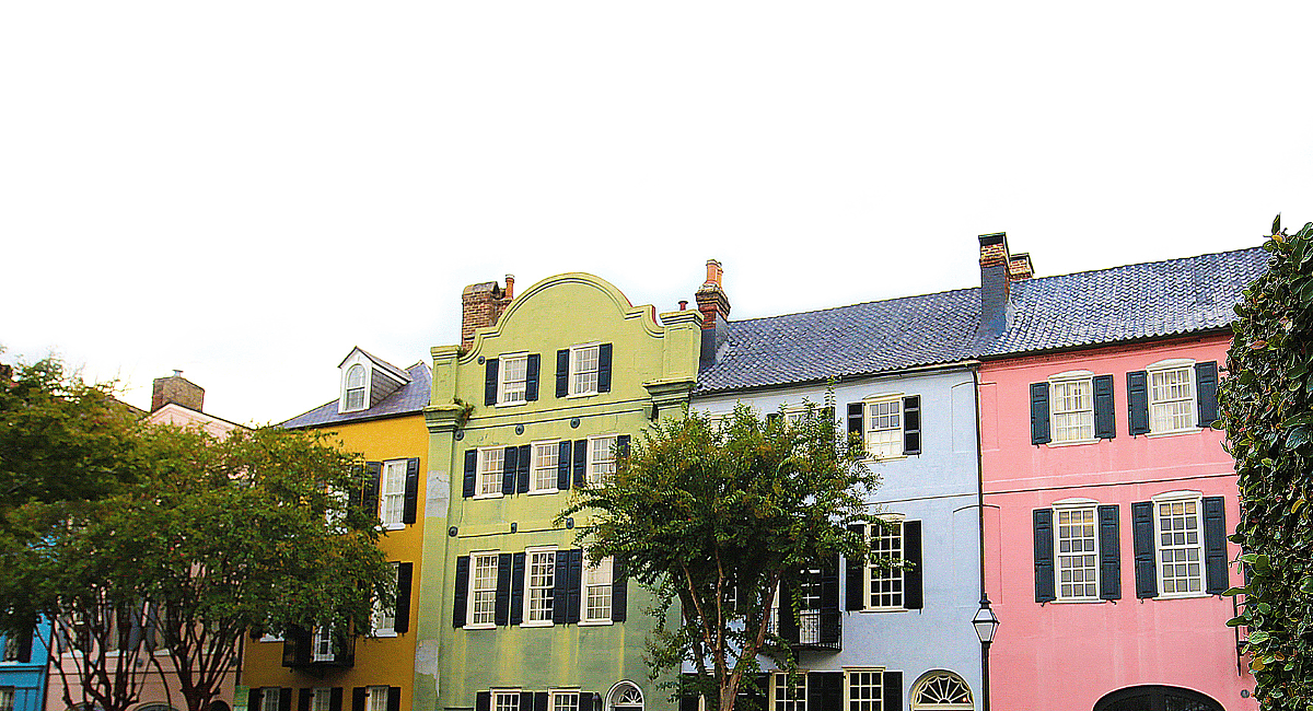 A row of colorful houses with shutters on the windows.