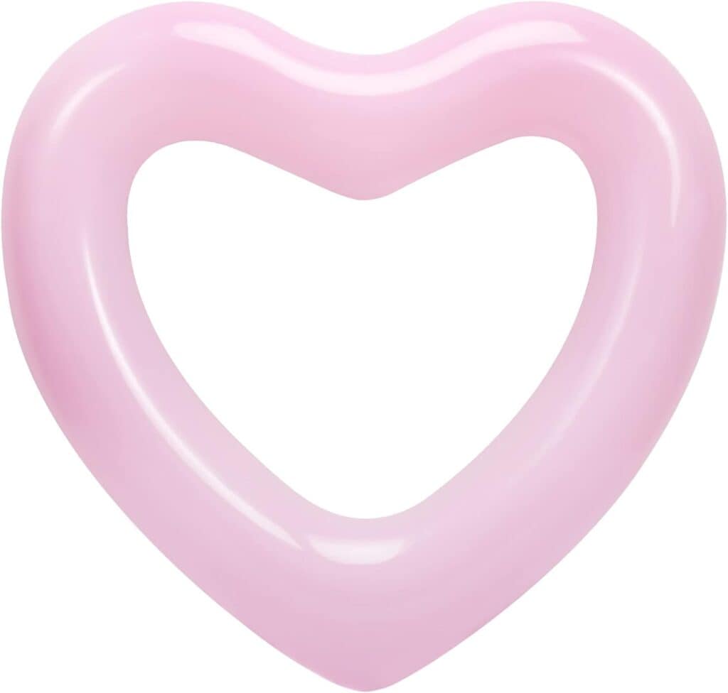 A pink heart shaped float floating in the water.