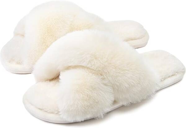 A pair of white slippers on top of the floor.