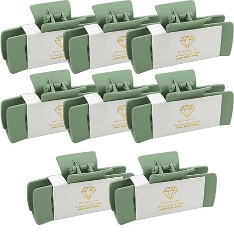 A set of eight green and white boxes with gold labels.