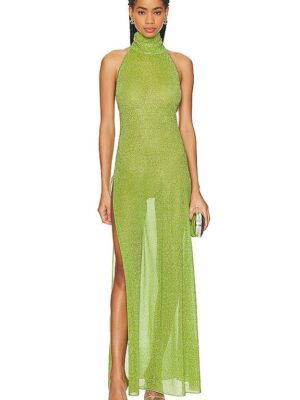 A woman in a green dress standing up