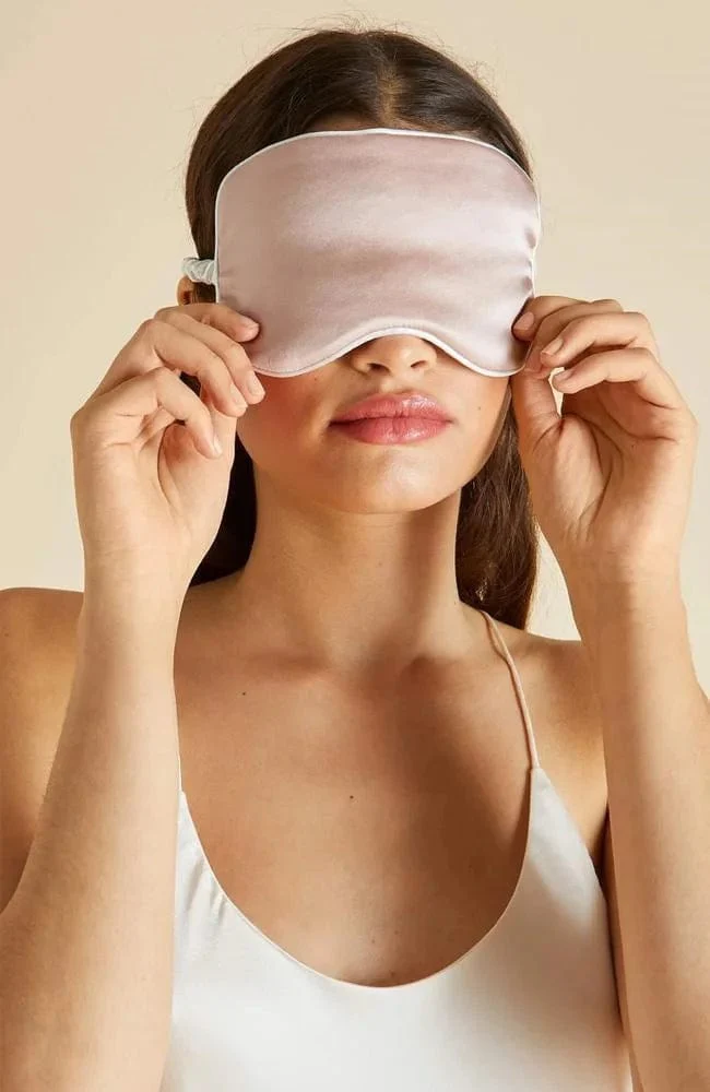 Sheer Olivia Von Halle silk oyster ivory eyemask on a woman